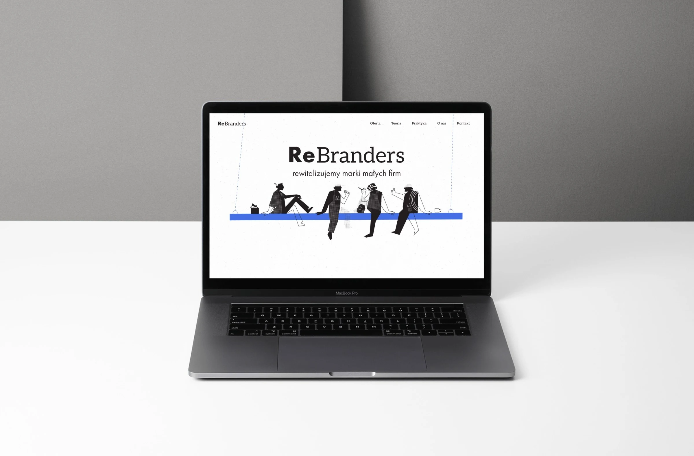 rebranders.pl — projekt strony internetowej, mockup macbook scena biurko